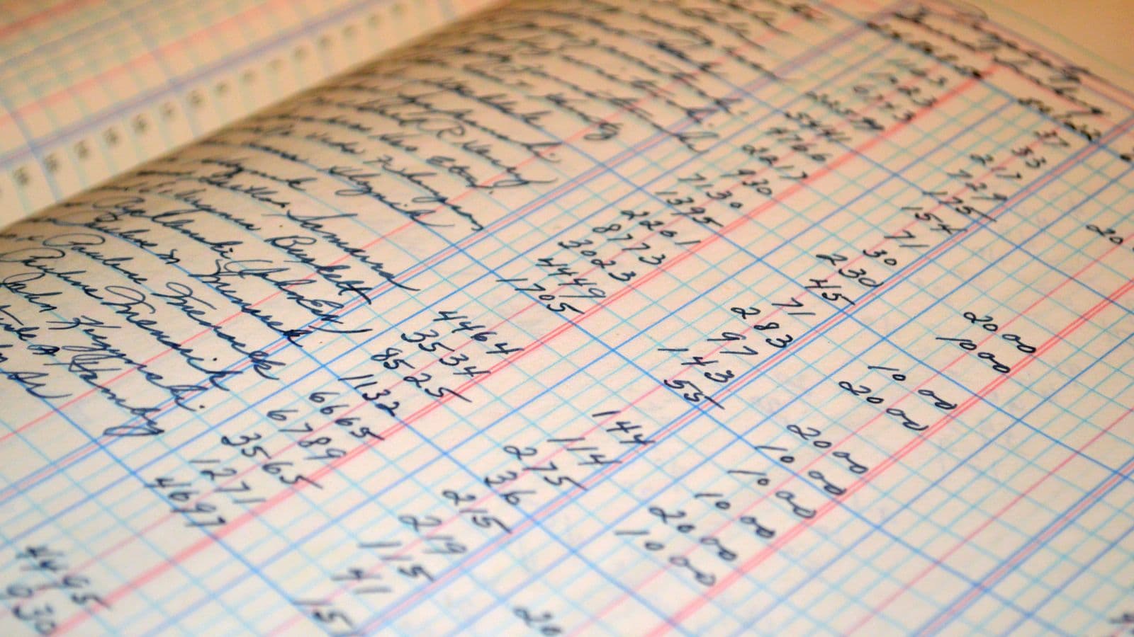 Finance professional comparing a general ledger and source records for a general ledger reconciliation